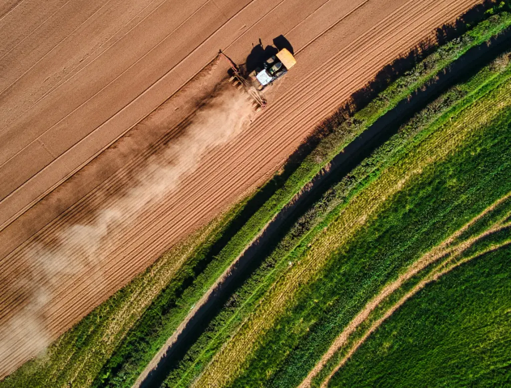 arial view of tractor ploughing field